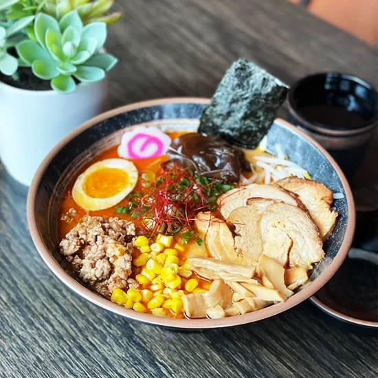 ramen bowl with check and an egg